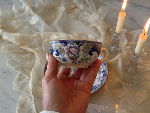 Profile of the cup showing the hand-painted polychrome floral motifs