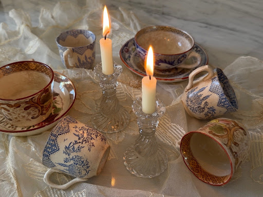 The cup and saucer resting elegantly on vintage lace