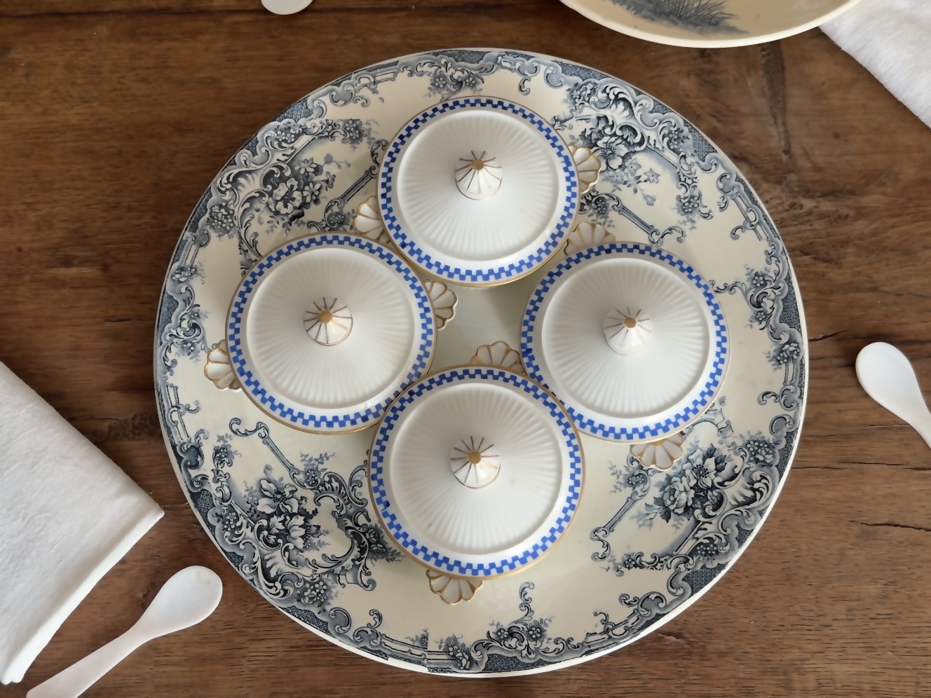 The porcelain pots displayed with lids resting gently beside them