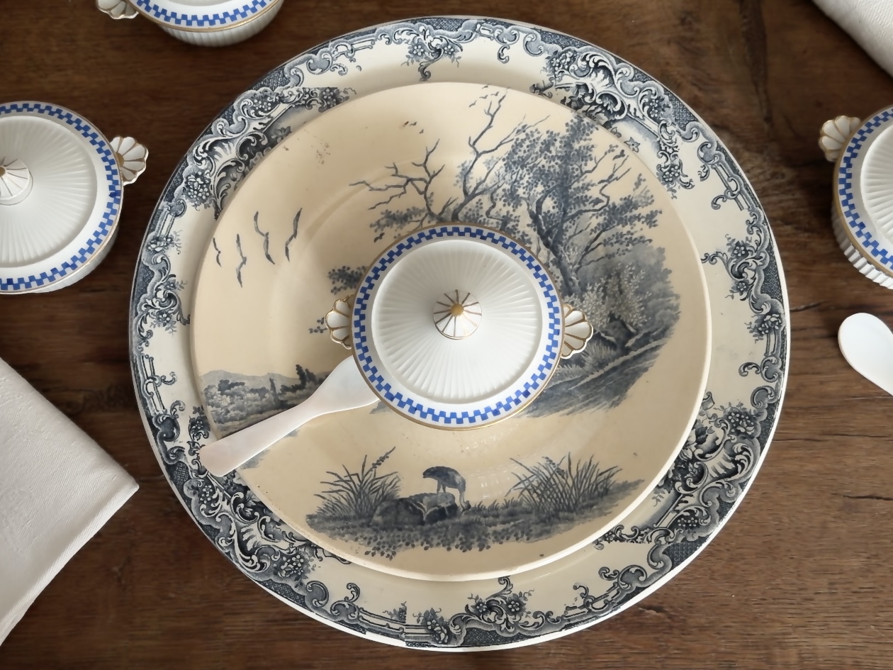 A single Pillivuyt pot resting beautifully on a scenic transferware plate