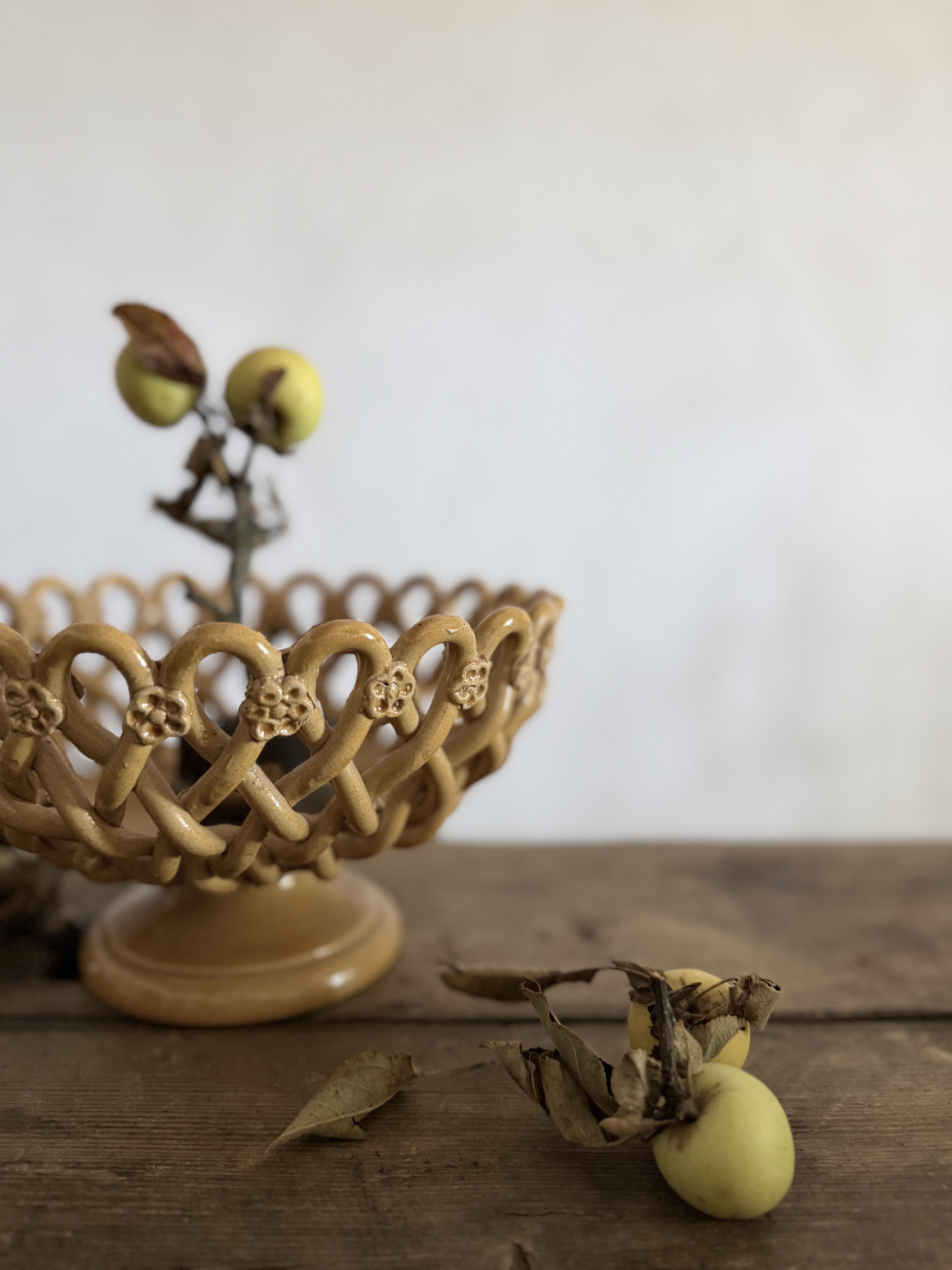 Close up detail of the hand-woven terre tressee ribbons of clay and floral rosettes