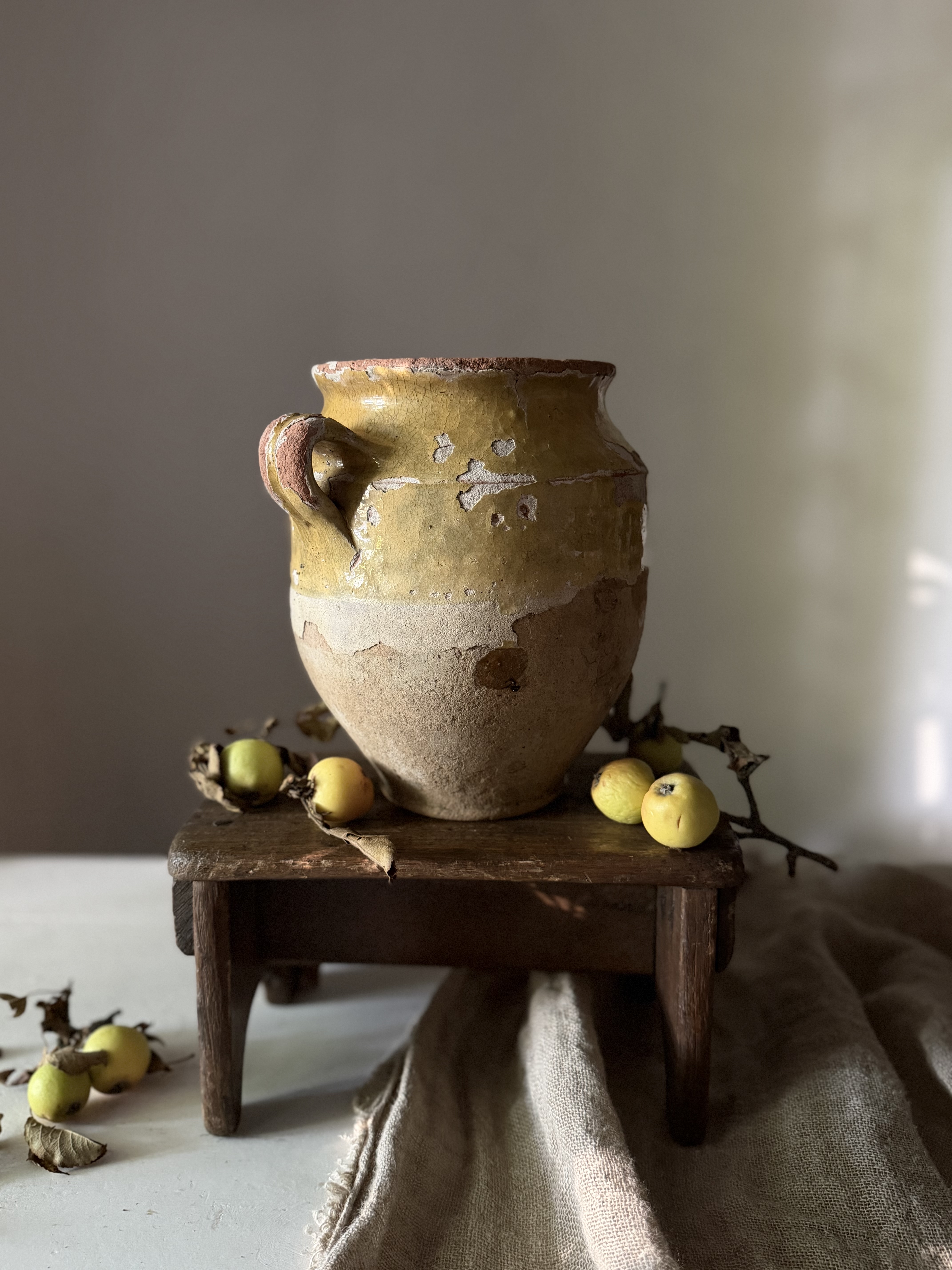 Antique French confit pot showing heavy glaze loss and wear