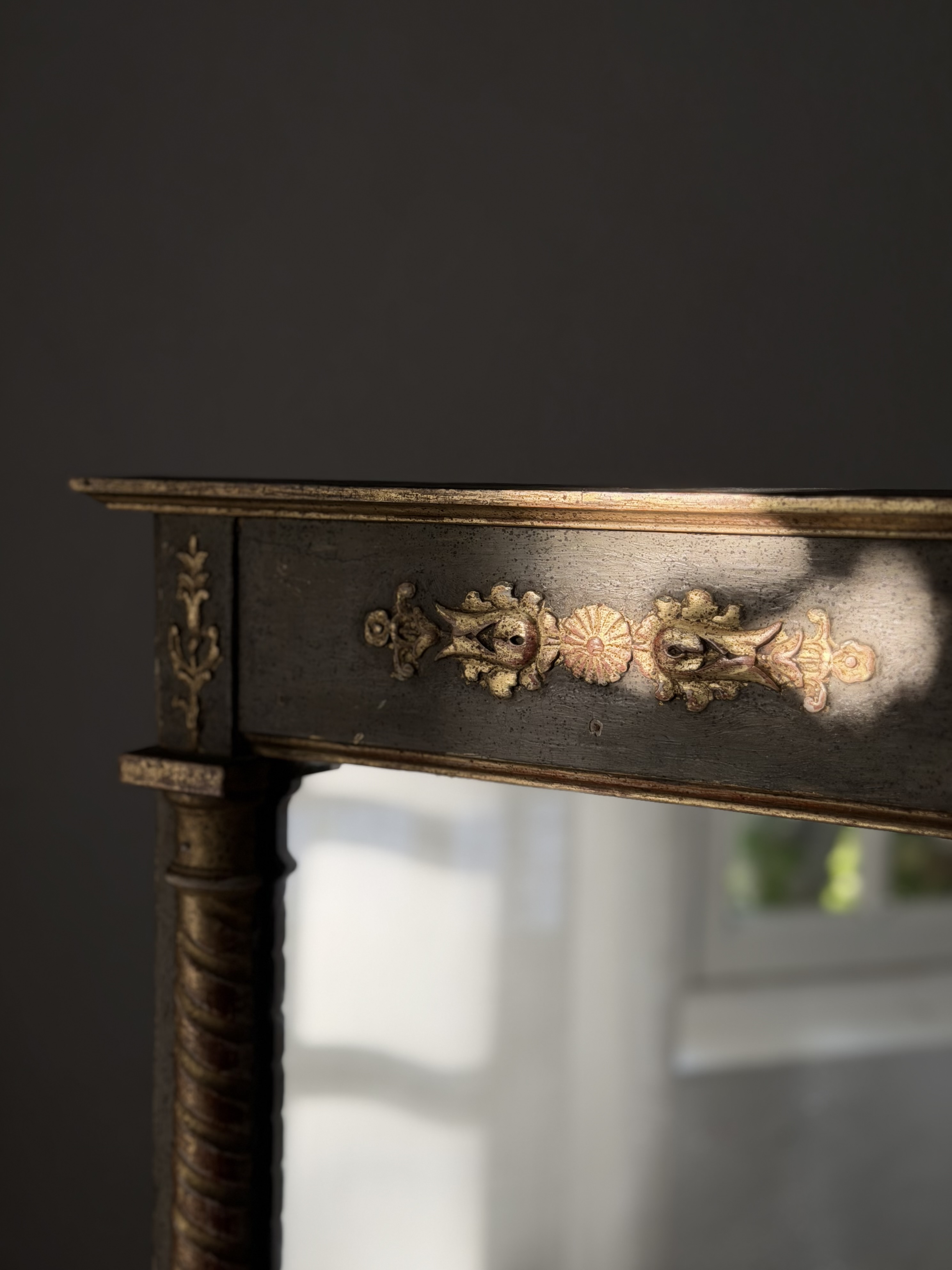 Close-up detail of the molded cornice and applied golden rosettes