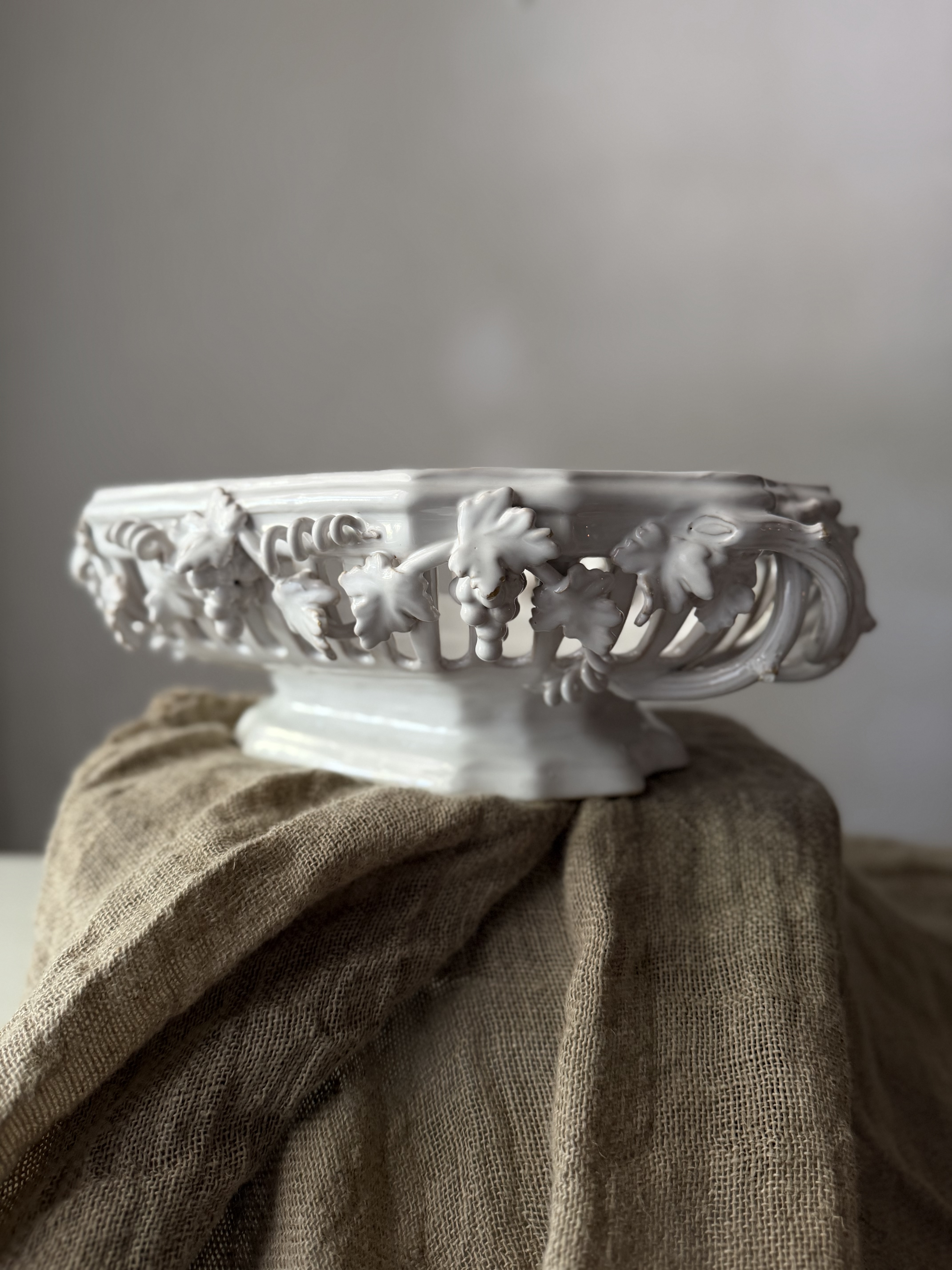 Angled profile showing the intricate pierced lattice rim